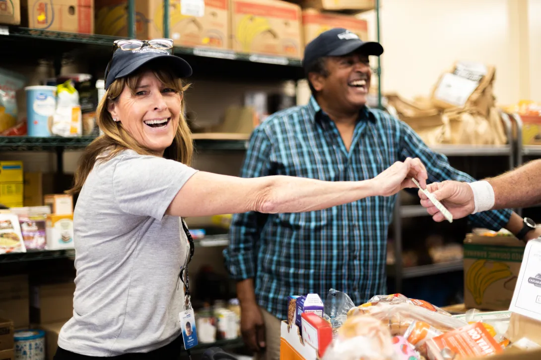 Volunteers handing grocery slip